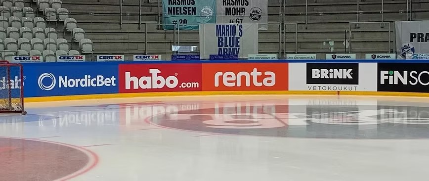 LED perimeter advertising boards curving around the edge of a live indoor sports arena